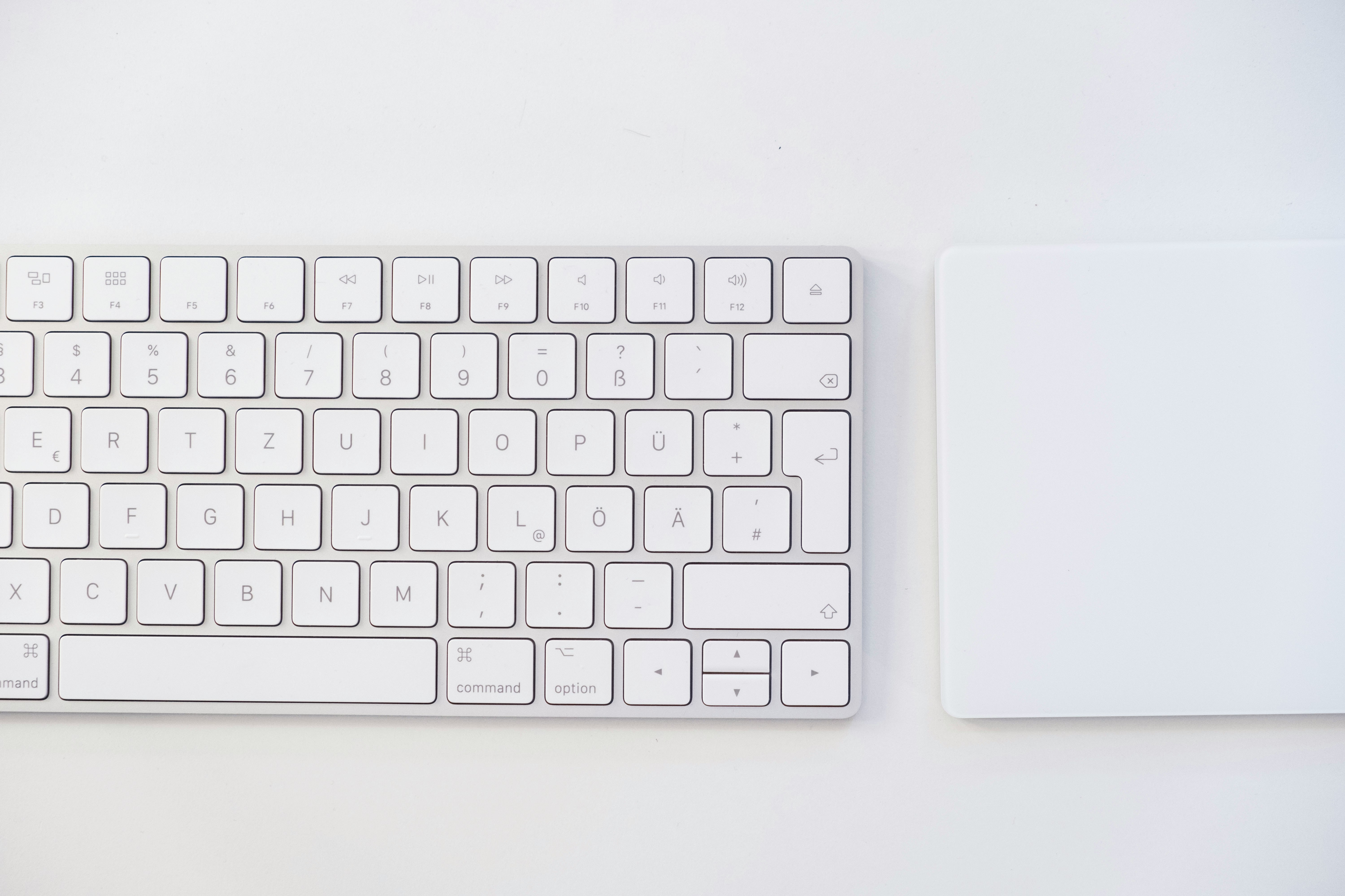 white apple keyboard on white table